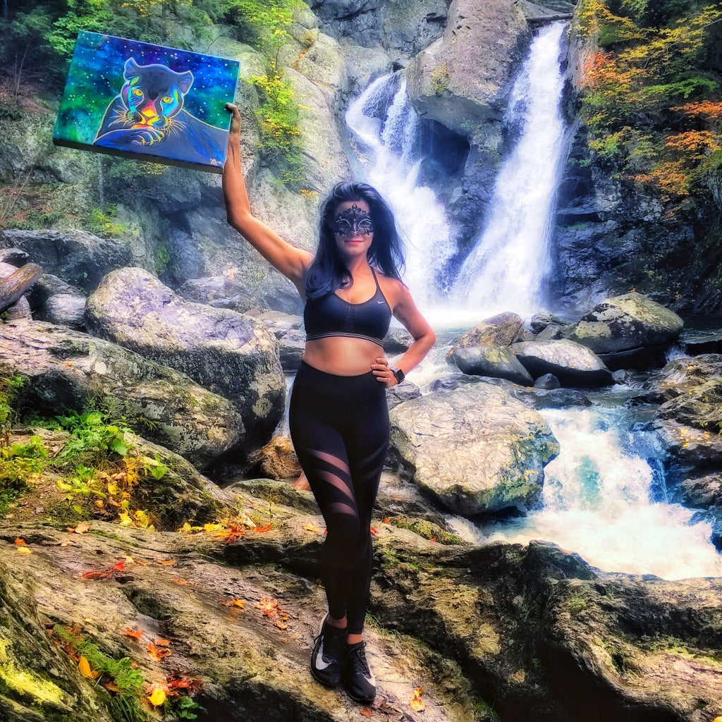 Holding the Panther painting in front of a waterfall