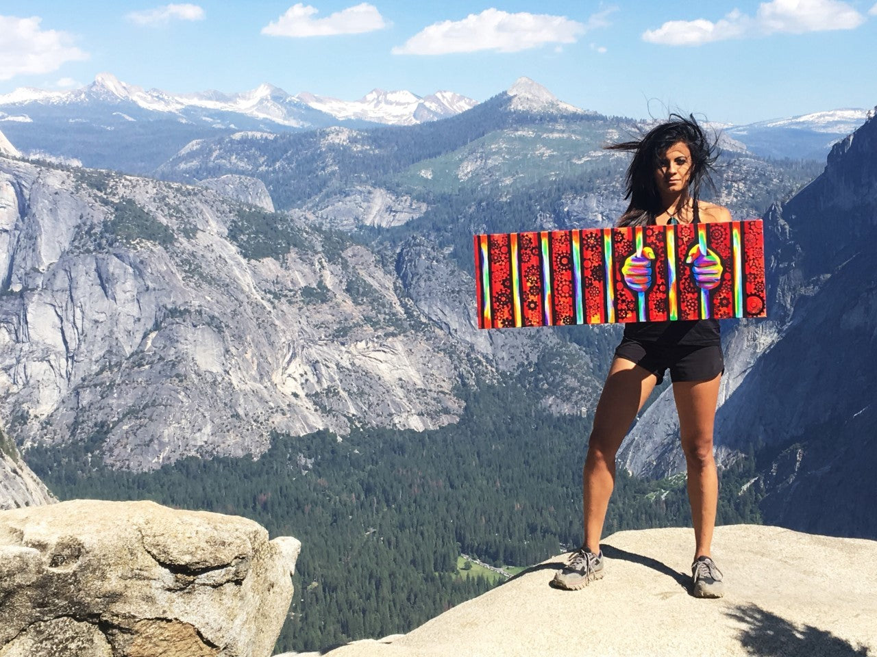 Holding a painting on top of Yosemite Falls